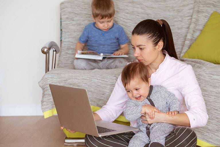Mother working from home with small children.