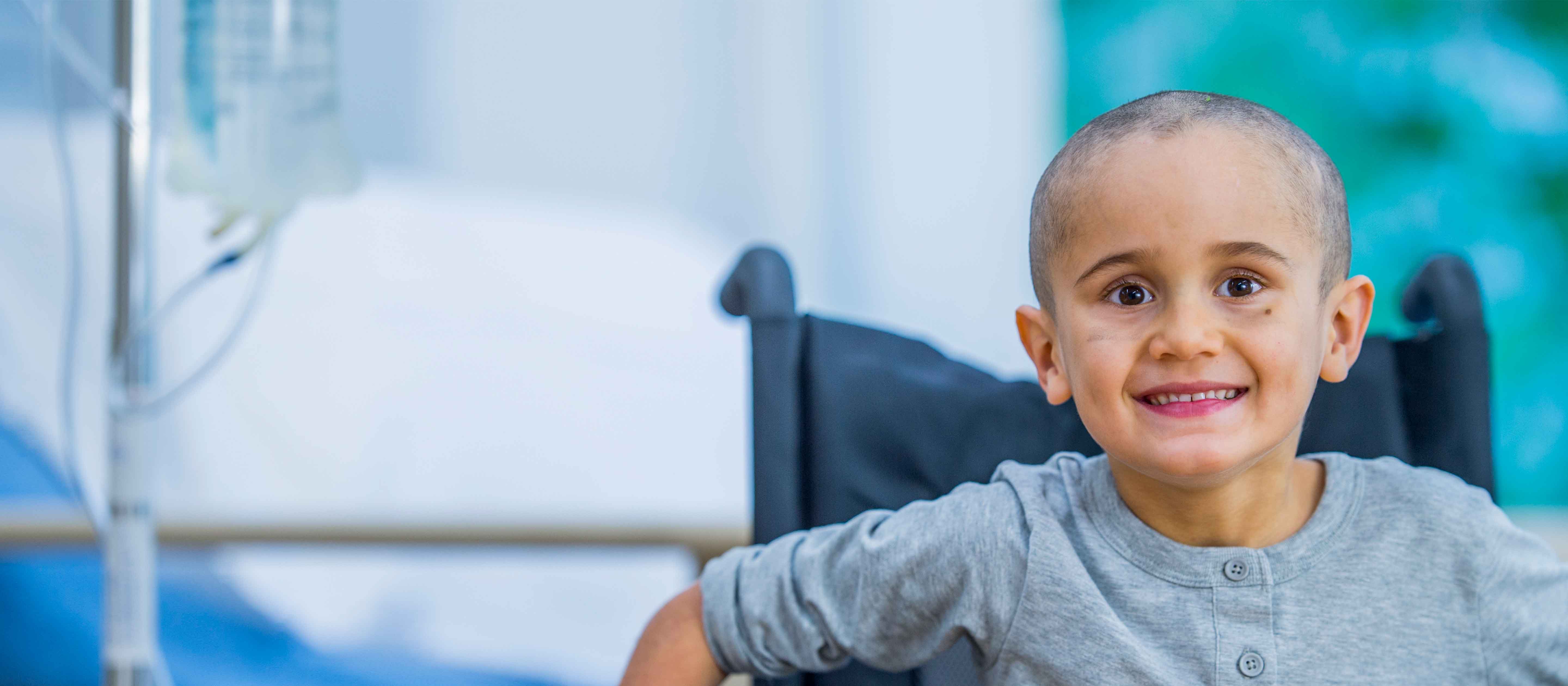 Smiling boy in wheelchair.