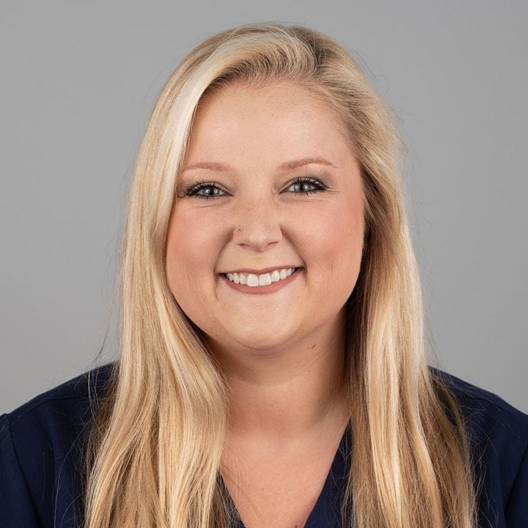 Blonde woman smiling.