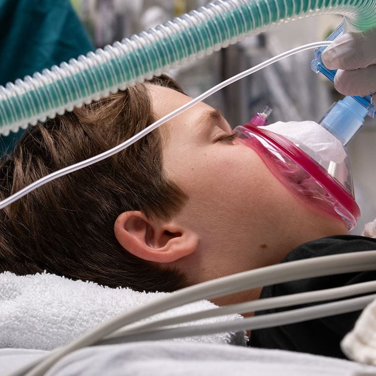 Male patient wearing mask in operating room.