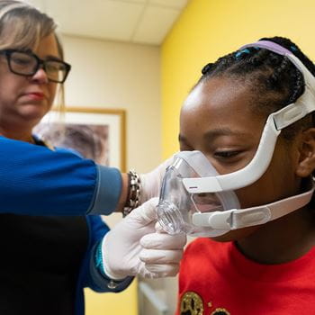 Pulmonary patient being fitted for cpap mask.