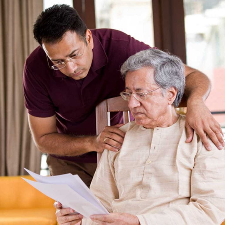 Father and son reading document.