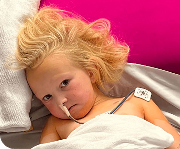 Female patient in hospital bed.